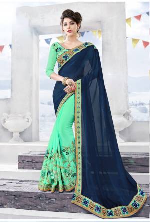 Here Is Pretty Designer Saree In Cool Color Pallete, This Saree Is In Navy Blue And Sea Green Color Paired With Sea Green Colored Blouse. This Saree Is Fabricated On Chiffon Paired With Art Silk Fabricated Blouse. 
