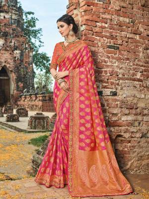 Wear this pink and orange color banarasi silk jacquard saree. Ideal for party, festive & social gatherings. this gorgeous saree featuring a beautiful mix of designs. Its attractive color and designer heavy embroidered design, zari resham work, stone design, banarasi silk sarees, beautiful floral design work over the attire & contrast hemline adds to the look. Comes along with a contrast unstitched blouse.