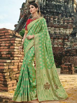 The fabulous pattern makes this saree a classy number to be included in your wardrobe. Light green color banarasi silk jacquard saree. Ideal for party, festive & social gatherings. this gorgeous saree featuring a beautiful mix of designs. Its attractive color and designer heavy embroidered design, zari resham work, moti work, banarasi silk sarees, beautiful floral design work over the attire & contrast hemline adds to the look. Comes along with a contrast unstitched blouse.