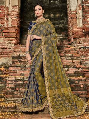 Wear this Navy Blue And Grey Two Tone color banarasi silk jacquard saree. Ideal for party, festive & social gatherings. this gorgeous saree featuring a beautiful mix of designs. Its attractive color and designer heavy embroidered design, zari resham work, stone work, banarasi silk sarees, beautiful floral design work over the attire & contrast hemline adds to the look. Comes along with a contrast unstitched blouse.