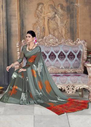 Flaunt Your Rich And Elegant Taste Wearing This Saree In Grey Color Paired With Grey Colored Blouse. This Saree And Blouse are Georgette Based Beautified With Satin Patta Prints. 