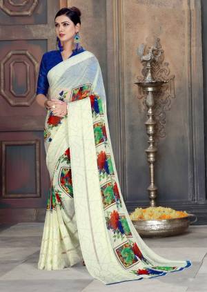 Simple And Elegant Looking Printed Saree In Here In White Color Paired With Royal Blue Colored Blouse. This Saree And Blouse Are Georgette Based Beautified With Satin Patta And Floral Prints All Over.