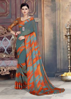 Elegant Looking Saree IS Here In Grey And Orange Color Paired With Orange And Grey Colored Blouse. This Saree Is Georgette Based Paired With Satin Georgette Fabricated Blouse. It Is Light Weight And Easy To Carry All Day Long.