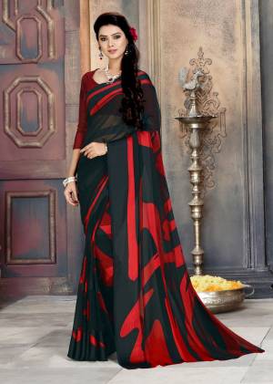 Add This Bold Looking Saree To Your Wardrobe For Casual Or Semi-Casual Wear In Black And Red Color Paired With Black And Red Colored Blouse. This Saree Is Fabricated On Georgette Paired With Satin Georgette Blouse. 