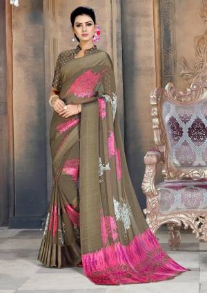Add This New Shade To Your Wardrobe With This Designer Saree In Sand Grey Color Paired With Sand Grey Colored Blouse. This Saree And Blouse Are Georgette Based Beautified With Prints And Satin Patta. 