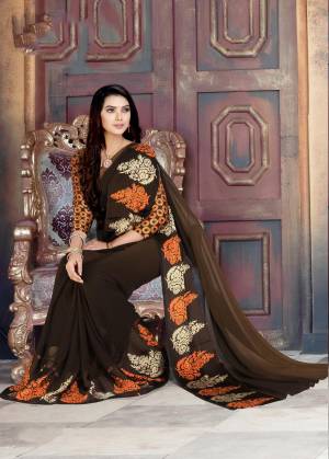 Enhance Your Beauty Wearing This Brown Colored Saree Paired With Brown and Orange Colored Blouse. This Saree And Blouse Are Georgette Based Which Is Comfortable To Carry And Also Durable.