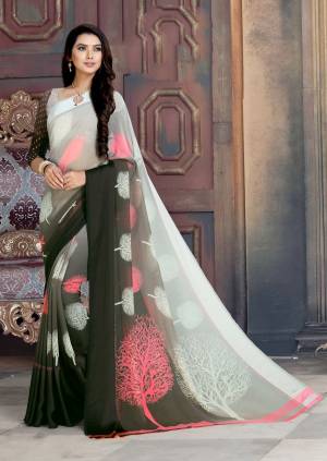 You Will Definitely Earn Lots Of Compliments Wearing This Saree In White And Dark Grey Color Paired With White And Dark Grey Colored Blouse. This Saree And Blouse Are Georgette Based Beautified With Very Pretty Prints.