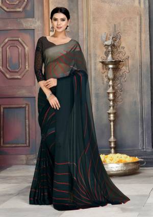 For A Bold And Beautiful Look, Grab This Saree In Black Color Paired With Black Colored Blouse. This Saree Is Georgette Fabricated Beautified With Prints And Satin Patta. 
