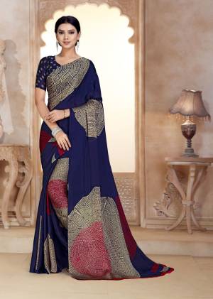 Enhance Your Personality Wearing This Navy Blue Color Paired With Navy Blue Colored Blouse. This Saree And Blouse Are Fabricated On Satin Georgette Beautified With Bold Prints. 
