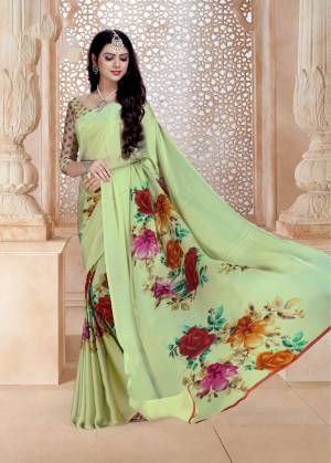 This Season Is About Subtle Shades And Pastel Play, So Grab This Saree In Pastel Green Color Paired With Pastel Green Colored Blouse. This Saree And Blouse Are Fabricated On Satin Georgette Beautified With Bold Multi Colored Floral Prints. 