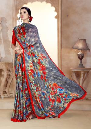 Simple Saree Is Here For Your Casual Wear In Grey And Red Color Paired With Red Colored Blouse. This Saree And Blouse Are Fabricated On Satin Georgette Beautified With Prints All Over. 