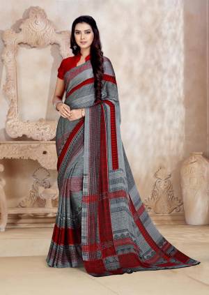 Simple Saree Is Here For Your Casual Wear In Grey And Maroon Color Paired With Maroon Colored Blouse. This Saree And Blouse Are Fabricated On Satin Georgette Beautified With Prints All Over. 