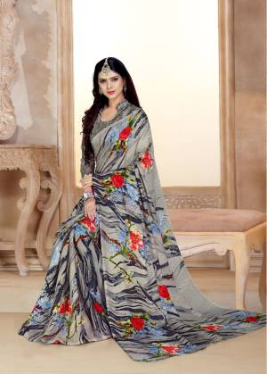 Flaunt Your Rich And Elegant Taste Wearing This Saree In Grey Color Paired With Grey Colored Blouse. This Saree And Blouse Are Satin Georgette Based Beautified With Contrasting Floral Prints. Also It Is Soft Towards Skin Which Is Easy To Carry All Day Long. 