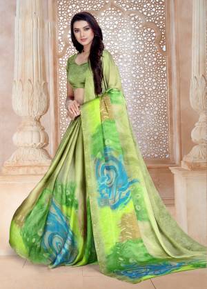 This Season Is About Subtle Shades And Pastel Play, So Grab This Saree In Light Green Color Paired With Light Green Colored Blouse. This Saree And Blouse Are Fabricated On Satin Georgette Beautified With Bold Floral Prints. 