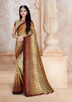 Simple Saree Is Here For Your Casual Wear In Beige And Brown Color Paired With Beige Colored Blouse. This Saree And Blouse Are Fabricated On Satin Georgette Beautified With Prints All Over. 