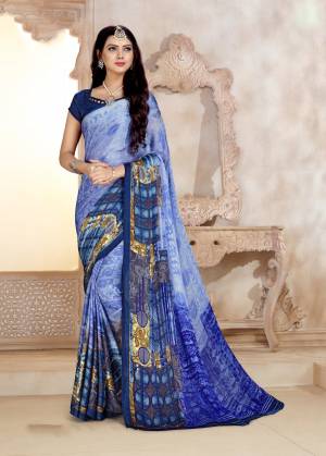 Grab This Pretty Blue Colored Saree Paired With Navy Blue Colored Blouse For Your Casual Wear, This Saree And Blouse Are Fabricated On Satin Georgette Beautified With Prints All Over. Buy Now.