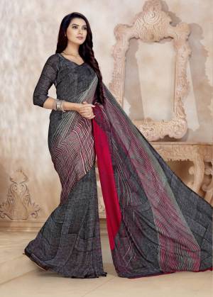 Flaunt your Rich And Elegant Taste Wearing This Saree In Dark Grey Color Paired With Dark Grey Colored Blouse. This Saree And Blouse Are Fabricated On Satin Georgette Beautified With Prints All Over. 