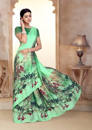 You Will Earn Lots Of Compliments Wearing This Pretty Shade In Light Green Colored Saree Paired With Green Colored Blouse. This Saree And Blouse Are Fabricated On Satin Georgette Beautified With Prints. 