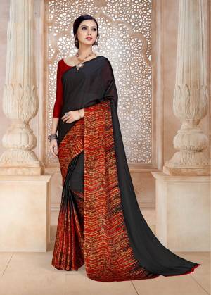 For A Bold And Beautiful Look, Grab This Saree In Black And Red Color Paired With Red Colored Blouse. This Saree And Blouse Are Fabricated On Satin Georgette Beautified With Prints Over The Saree Panel And Pallu.