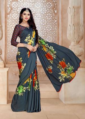 Flaunt your Rich And Elegant Taste Wearing This Saree In Dark Grey Color Paired With Dark Grey Colored Blouse. This Saree And Blouse Are Fabricated On Satin Georgette Beautified With Bold Multi Colored Floral Prints All Over. 