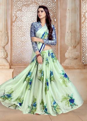 This Season Is About Subtle Shades And Pastel Play, Grab This Saree In Pastel Green Color Paired With Blue Colored Blouse. This Saree And Blouse Are Fabricated On Satin Georgette Beautified With Bold Floral Prints.