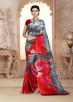 Grab This Beautiful Saree In Grey And Red Color Paired With Red Colored Blouse. This Saree And Blouse Are Fabricated On Satin Georgette Beautified With Prints All Over. 