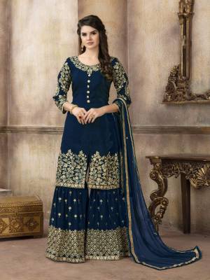 Enhance your Personality Wearing This Designer Sharara Suit In Navy Blue Color Paired With Navy Blue Colored Bottom And Dupatta. Its Top Is Silk based paired With Georgette Bottom And Net Dupatta. All Its Fabric Ensures Superb Comfort All Day Long. 