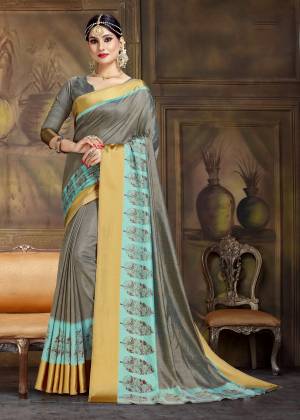 Flaunt Your Rich And Elegant Taste Wearing This Designer Silk Based Printed Saree In Dark Grey Color Paired With Dark Grey Colored Blouse. It Has Very Pretty Border Print Giving It An Attractive Look.