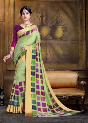 For A Proper Traditional Look, Grab This Pretty Saree In Light Green Color Paired With Purple Colored Blouse. This Saree And Blouse Are Fabricated On Art Silk Beautified With Bold Floral Prints All Over