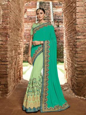 Show your elegance by wearing this gorgeous Sea green and Pastel green color two tone silk and silk fabrics saree. Ideal for party, festive & social gatherings. this gorgeous saree featuring a beautiful mix of designs. Its attractive color and designer heavy embroidered design, stone and zari design work, patch design and heavy designer blouse, beautiful floral design all over in saree work over the attire & contrast hemline adds to the look. Comes along with a contrast unstitched blouse.