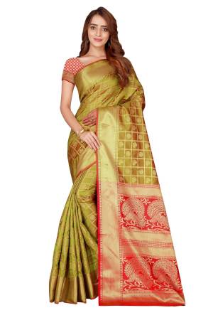 Here Is A Very Pretty Color Pallete With this Silk Based Saree In Pear Green And Red Color Paired With Red Colored Blouse. This Saree And Blouse Are Fabricated On Kanjivaram Art Silk Beautified With Heavy weave All Over It. Buy This Designer Silk Saree Now.