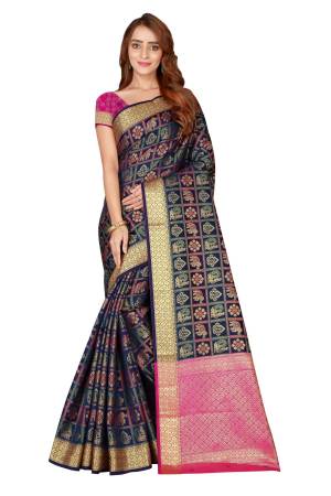 Celebrate This This Festive Season With This Designer Silk Based Saree In Navy Blue Color Paired With Contrasting Dark Pink Colored Blouse. This Saree And Blouse Are Fabricated On Kanjivaram Art Silk Beautified With Weave All over It.