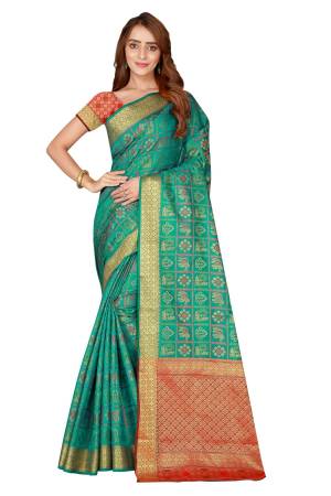 Celebrate This This Festive Season With This Designer Silk Based Saree In Sea Green Color Paired With Contrasting Orange Colored Blouse. This Saree And Blouse Are Fabricated On Kanjivaram Art Silk Beautified With Weave All over It.