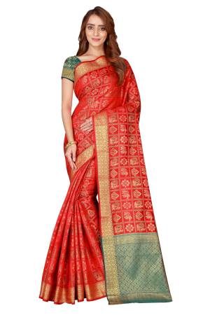 Celebrate This This Festive Season With This Designer Silk Based Saree In Red Color Paired With Contrasting Green Colored Blouse. This Saree And Blouse Are Fabricated On Kanjivaram Art Silk Beautified With Weave All over It.