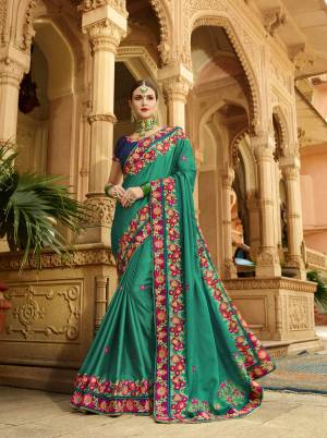 For A Proper Traditional Look, Grab This Beautiful Designer Saree In Green Color Paired With Contrasting Navy Blue Colored Blouse. This Saree And Blouse Are Silk Based Beautified With Heavy And Attractive Embroidery .