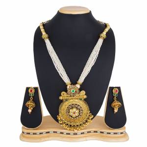 Here Is A Beautiful Long Pattern Necklace Set In Golden Color Beautified with Stone Work And Pair With A Lovely Pair Of Earrings. You Can Pair This Up With Any Colored Traditional Attire. 