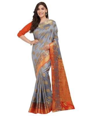 Flaunt Your Rich And Elegant Taste Wearing This Silk Based Saree With Rich Color Pallete. This Saree Is In Grey And Orange Color Paired With Orange Colored Blouse. Both Are Fabricated On Nylon Silk Which Is Light Weight And Easy To Carry.