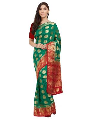 Celebrate This Festive Season With This Saree In Teal Green And Red Color Paired With Red Colored Blouse. This Saree And Blouse Are Fabricated On Nylon Silk Beautified With Weave All Over. 