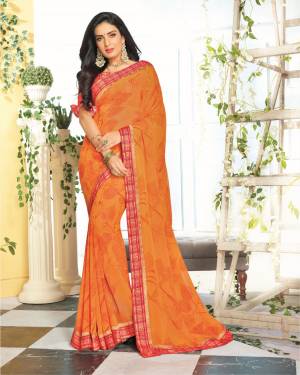 Orange And Red Color Induces Perfect Summery Appeal To Any Outfit, So Grab This Saree In Orange Color Paired With Contrasting Red Colored Blouse. This Saree Is Georgette Based Paired With Satin Fabricated Blouse. 