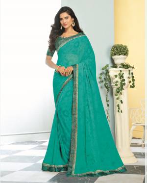 Here Is A Pretty Shade In Blue With This Saree In Turquoise Blue Color Paired With Turquoise Blue Colored Blouse. This Saree Is Fabricated On Georgette Paired With Satin Fabricated Blouse. Both Its Fabrics Are Soft Towards Skin And Ensures Superb Comfort All Day Long. 