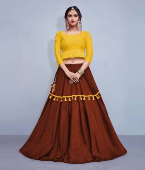 This Festive Season, Look The Most Unqiue And Trendy With This Designer Readymade Lehenga Choli In Yellow Colored Blouse Paired With Contrasting Brown Colored Lehenga. Its Blouse Is Silk Based With Cotton Fabricated Lehenga. It IS Beautified With Multi Colored Tassels And Lace. 