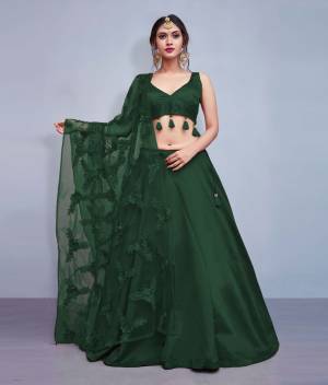Earn Lots Of Compliments Wearing This Designer Lehenga Choli In Pine Green Color Paired With Pine Green Colored Dupatta. Its Blouse And Lehenga Are Silk Based Paired With Heavy Embroidered Net Fabricated Dupatta. Also Its Blouse Is Beautified With Tassels Giving It A Lovely Sleek Look.