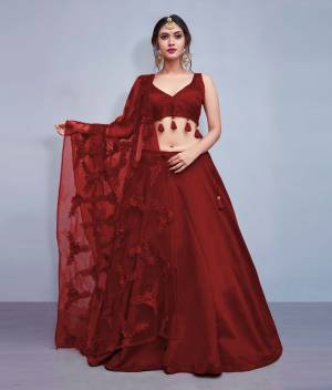 Earn Lots Of Compliments Wearing This Designer Lehenga Choli In Maroon Color Paired With Maroon Colored Dupatta. Its Blouse And Lehenga Are Silk Based Paired With Heavy Embroidered Net Fabricated Dupatta. Also Its Blouse Is Beautified With Tassels Giving It A Lovely Sleek Look.