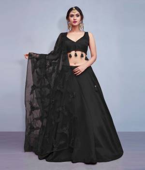 Earn Lots Of Compliments Wearing This Designer Lehenga Choli In Black Color Paired With Black Colored Dupatta. Its Blouse And Lehenga Are Silk Based Paired With Heavy Embroidered Net Fabricated Dupatta. Also Its Blouse Is Beautified With Tassels Giving It A Lovely Sleek Look.