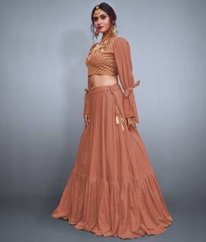 Get Ready For the Upcoming Festive And Wedding Season With This Designer Lehenga And Choli In Dark Peach. It Is Fabricated On Crepe Silk With Heavy Embroidered Blouse And Pattern Play. 