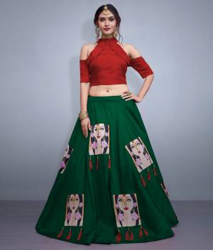 Here Is A Lovely Patterned Designer Lehenga Choli For Festive, Marriage Or Any Occasion Wear. Its Blouse Is In Maroon Color Paired With Contrasting Dark Green Lehenga. Its Blouse IS Fabricated On Nylon Silk Paired With Art Silk Lehenga. It IS Beautified with Patch Work And Tassels. 