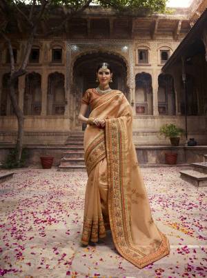 Celebrate This Festive Season Wearing This Designer Saree In Beige Color Paired With Red Colored Blouse. This Saree  Is Fabricated On Orgenza Paired With Art Silk Fabricated Blouse, It Is Beautified With Heavy Embroidery. 