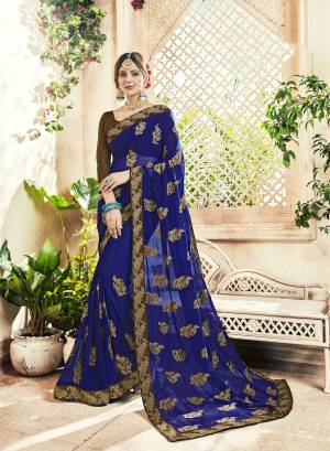 Bright And Visually Appealing Color Is Here With This Designer Saree In Royal Blue Color Paired With Brown Colored Blouse. This Saree Is Fabricated On Georgette Paired With Art Silk Fabricated Blouse. 