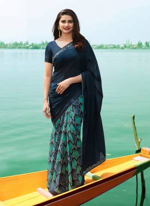 Go With This Shades Of Green With This Lovely Georgette Based Saree In Navy Blue And Blue Color Paired With Navy Green Colored Blouse. This Saree Is Fabricated On Georgette Paired With Art Silk Fabricated Blouse. Buy This Now.