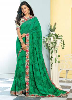 Add This Shade To Your Wardrobe With This Saree In Green Color Paired With Cream Colored Blouse. This Saree IS Georgette Based Paired With Satin Fabricated Blouse. 